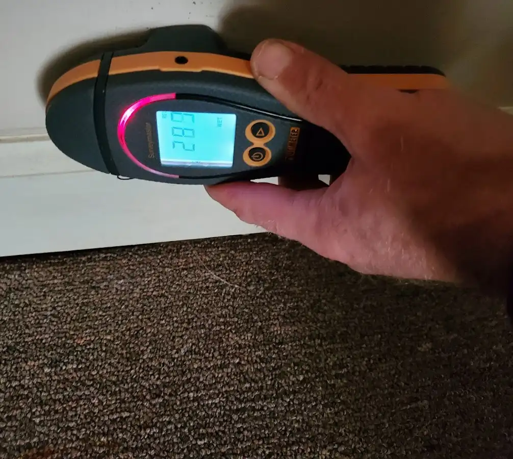 Moisture detection at baseboard during Storm Damage Restoration in Laughlin